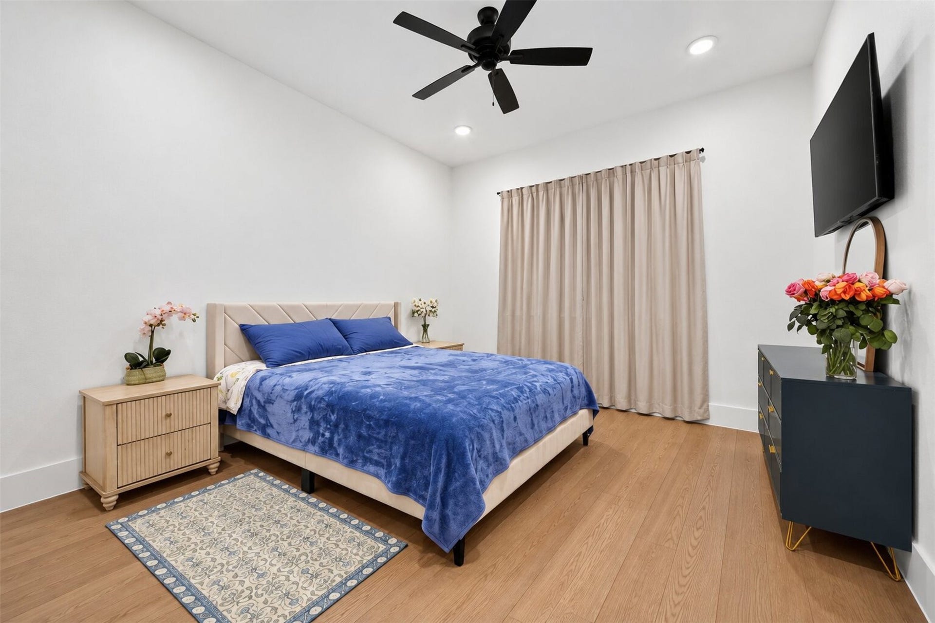 35851 Pineridge Road, Waller, TX 77484 Wide windows and a ceiling fan give this secondary bedroom a bright, open feel, while wood-look flooring continues the home's finishes.