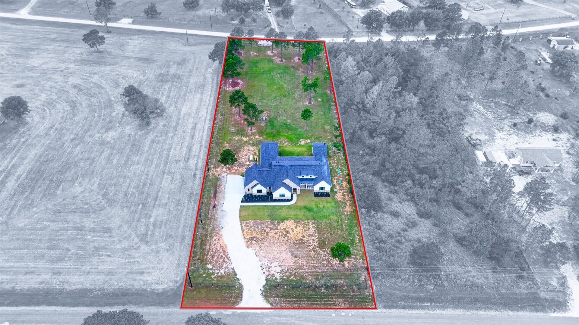 35851 Pineridge Road, Waller, TX 77484 An aerial view highlights the home, driveway, and open grounds within the red-outlined property boundary.