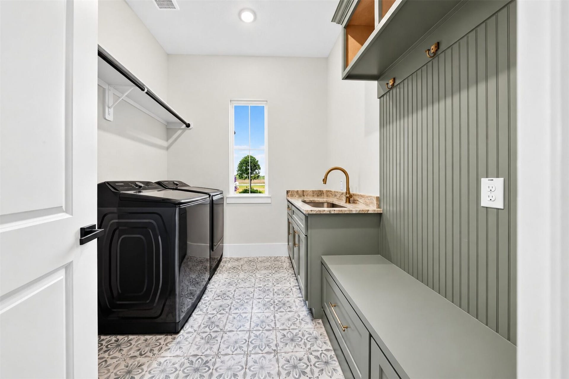 35851 Pineridge Road, Waller, TX 77484 Built-in cabinetry and a utility sink add everyday function, while patterned tile brings detail to the laundry room floor.
