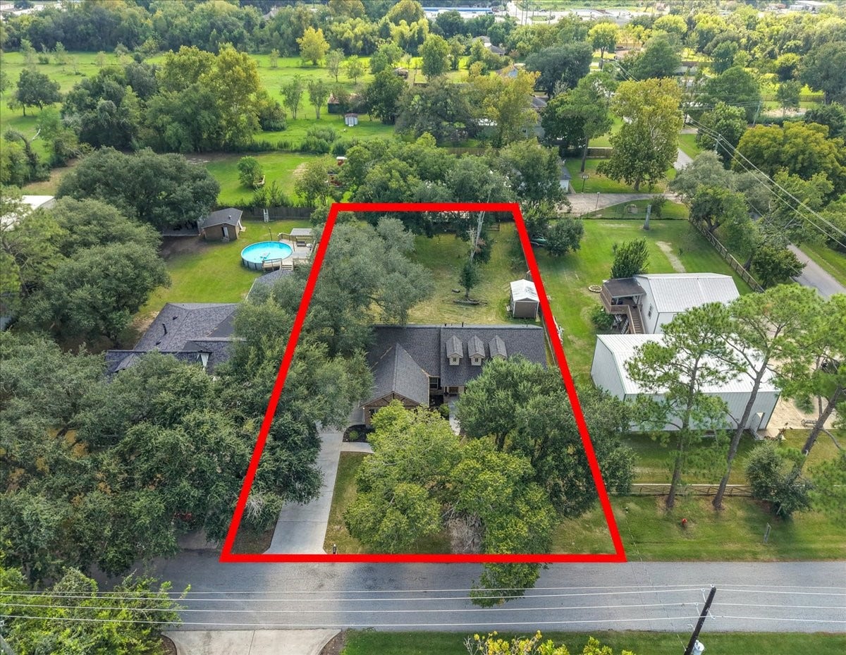 15531 Maple Street, Santa Fe, TX 77517 This bird's-eye view captures the full scope of the property, half an acre of shaded, usable yard space stretching from the front drive back through mature trees to the rear grounds. Plenty of room to spread out, garden, or add your own outdoor amenities.