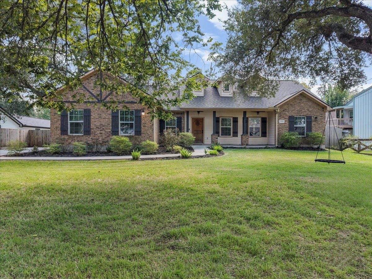 15531 Maple Street, Santa Fe, TX 77517 Crisp black shutters and thoughtful landscaping frame a sprawling lawn, perfect for play, pets, or weekend gatherings.