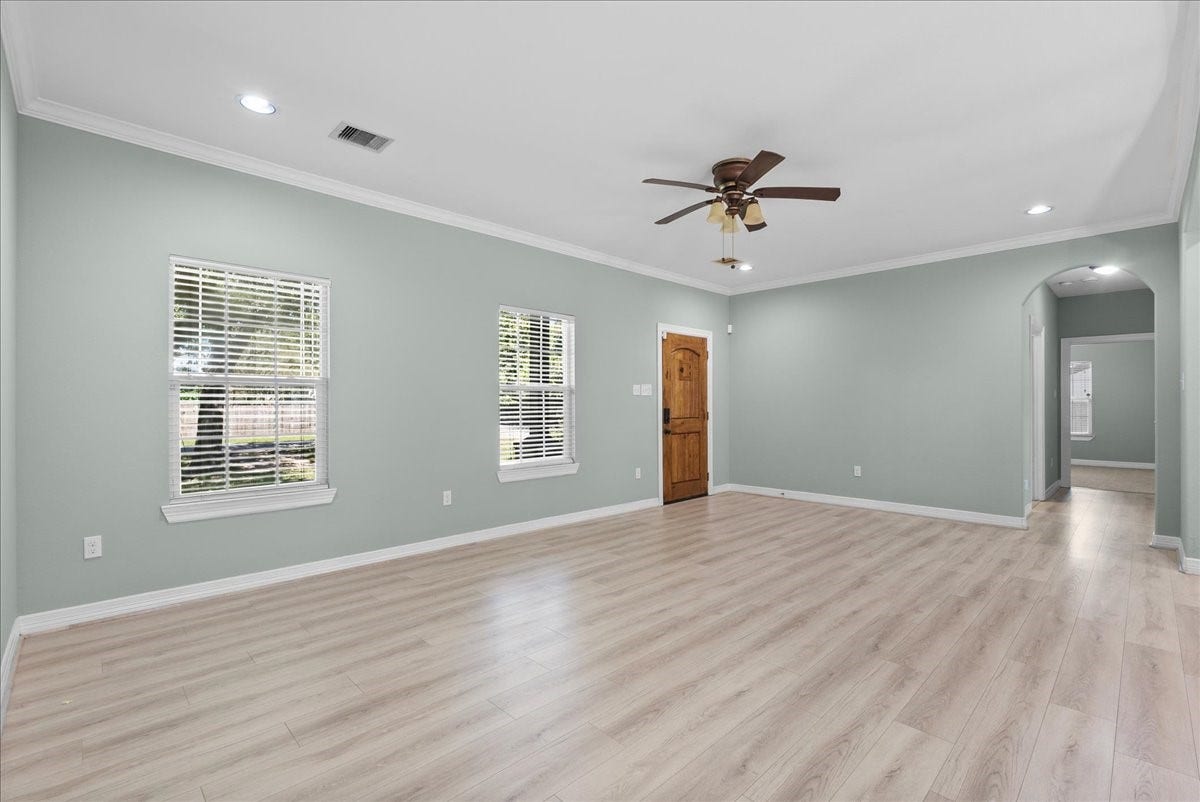 15531 Maple Street, Santa Fe, TX 77517 Vaulted transitions in the ceiling, a second ceiling fan, and continuous plank flooring tie the whole space together.