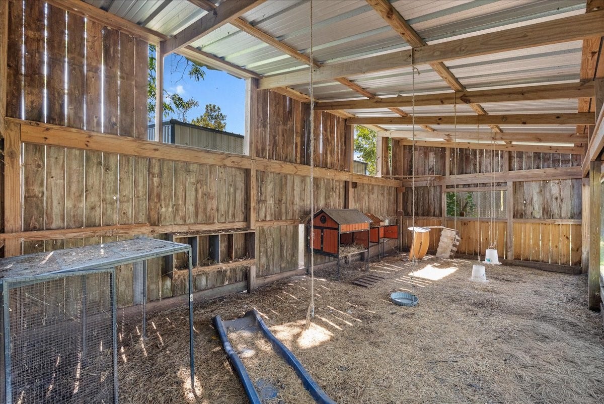 15531 Maple Street, Santa Fe, TX 77517 Built out with wood-plank walls, a durable metal roof, and wire-enclosed sections for secure housing, this spacious coop includes built-in nesting boxes and multiple roosting areas, a true turnkey setup for chickens or other small livestock.