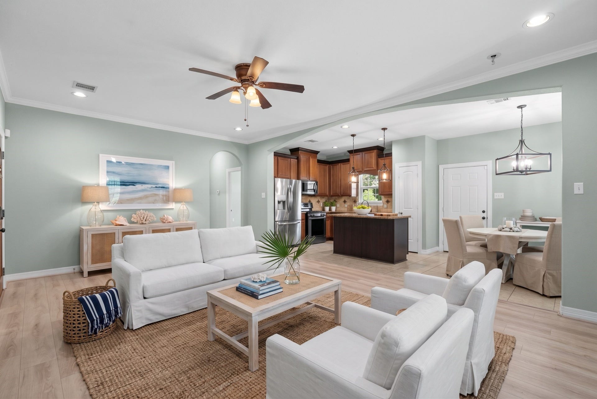 15531 Maple Street, Santa Fe, TX 77517 Wide-plank flooring runs throughout, and a ceiling fan plus recessed lighting complete the main living area, while an arched doorway adds architectural detail between rooms.