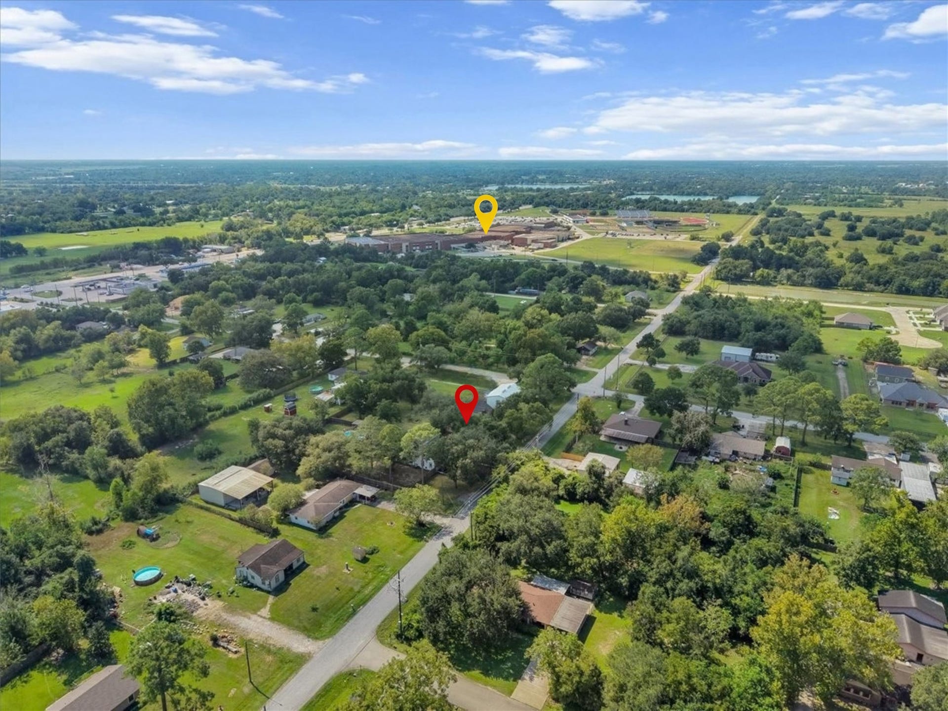 15531 Maple Street, Santa Fe, TX 77517 This aerial view says it all: mature trees, wide-open green space, and a true neighborhood feel, all just a short walk from Santa Fe High School (yellow pin) and its athletic fields.