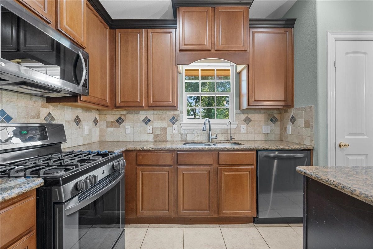 15531 Maple Street, Santa Fe, TX 77517 Abundant cabinet storage complete a layout that opens directly into the dining and living areas.