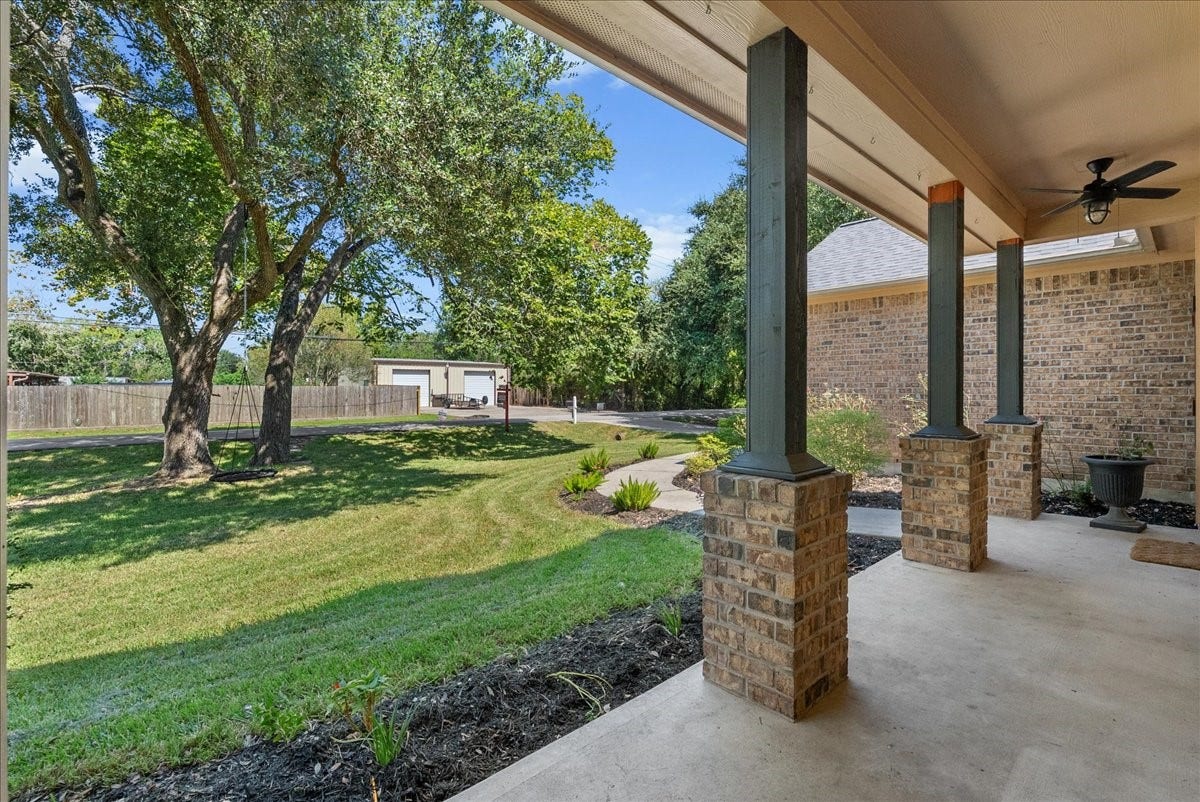 15531 Maple Street, Santa Fe, TX 77517 Relax on the covered front porch with a ceiling fan overhead and views out to mature shade trees and a manicured lawn, the kind of spot that turns coffee on the porch into a daily ritual.
