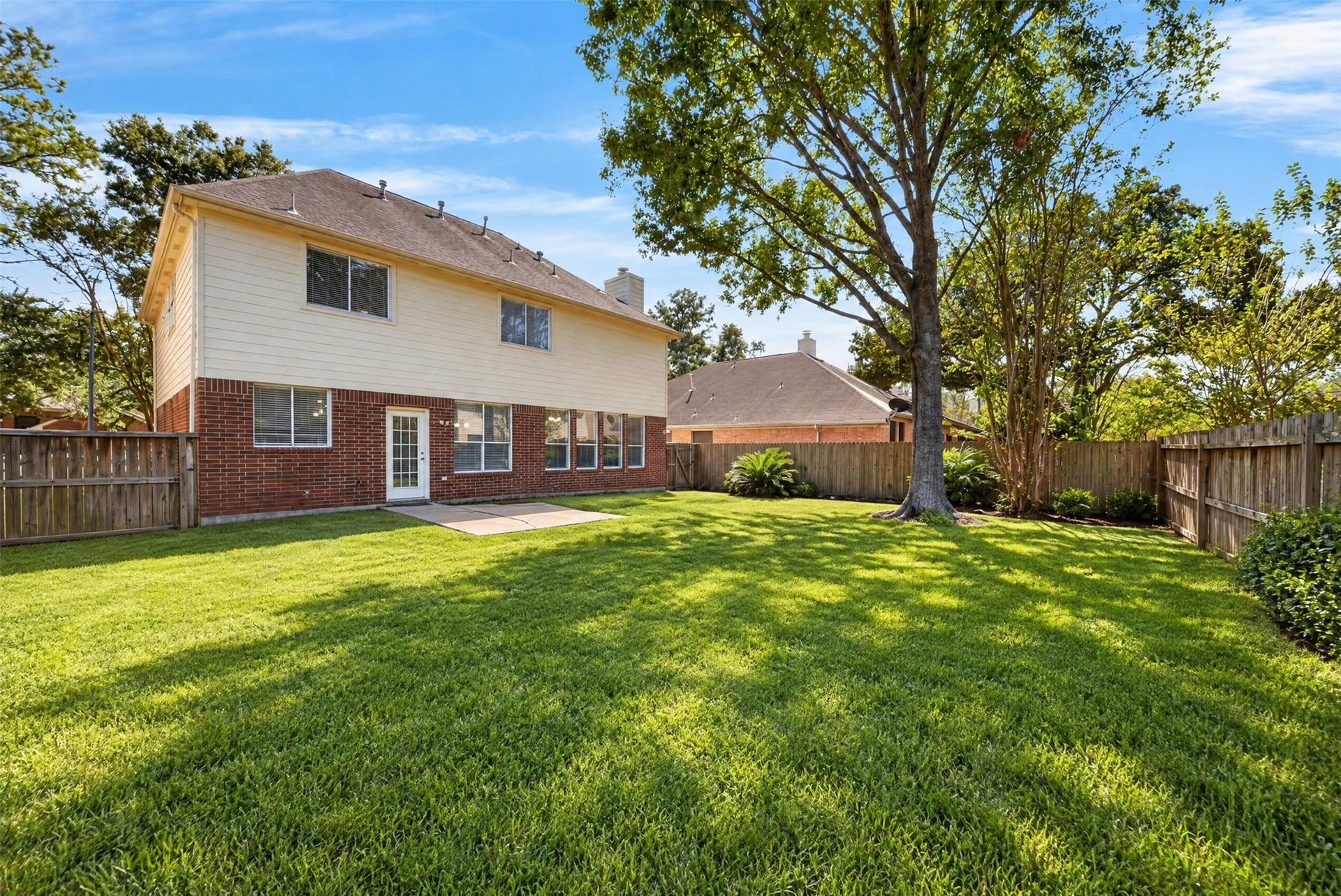 2130 Autumn Fern Drive, Katy, TX 77450 Backyard: Spacious fenced backyard with mature shade trees, lush lawn and patio space offers an inviting setting for outdoor living and entertaining.