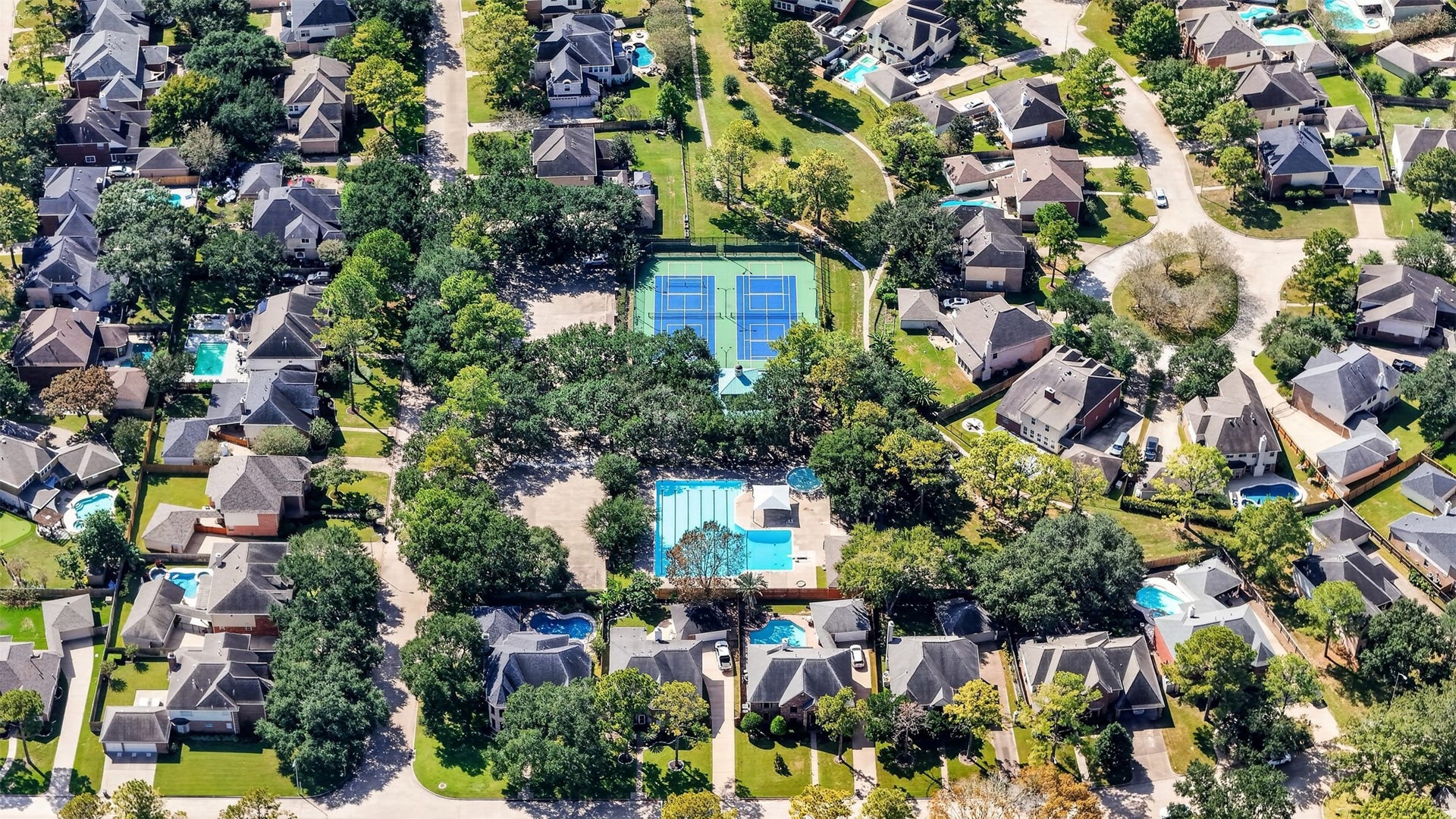 2130 Autumn Fern Drive, Katy, TX 77450 Aerial View Nearby Recreational Amenities
Aerial view highlights nearby recreational amenities, including a swimming pool, tennis courts and landscaped green spaces surrounded by mature trees.