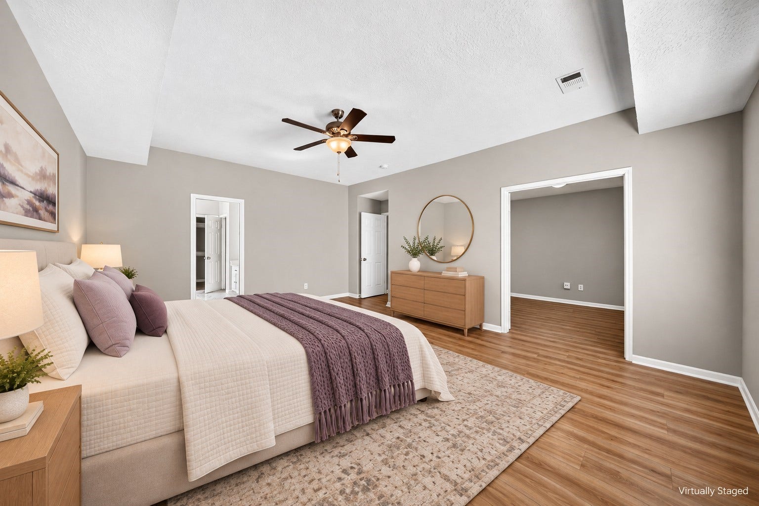 2130 Autumn Fern Drive, Katy, TX 77450 Primary Bedroom: Generously proportioned primary retreat with wood-look flooring, ceiling fan and ample space for a complete bedroom arrangement.