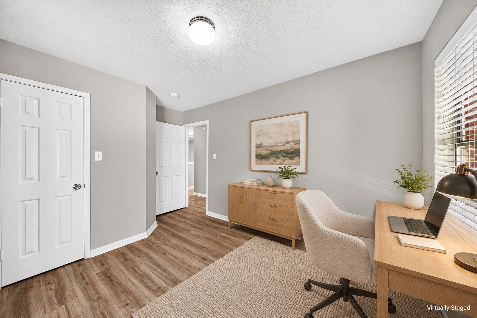 2130 Autumn Fern Drive, Katy, TX 77450 Office / Flex Room: Versatile room staged as a home office, featuring attractive wood-look flooring, closet storage and natural light for a comfortable workspace.