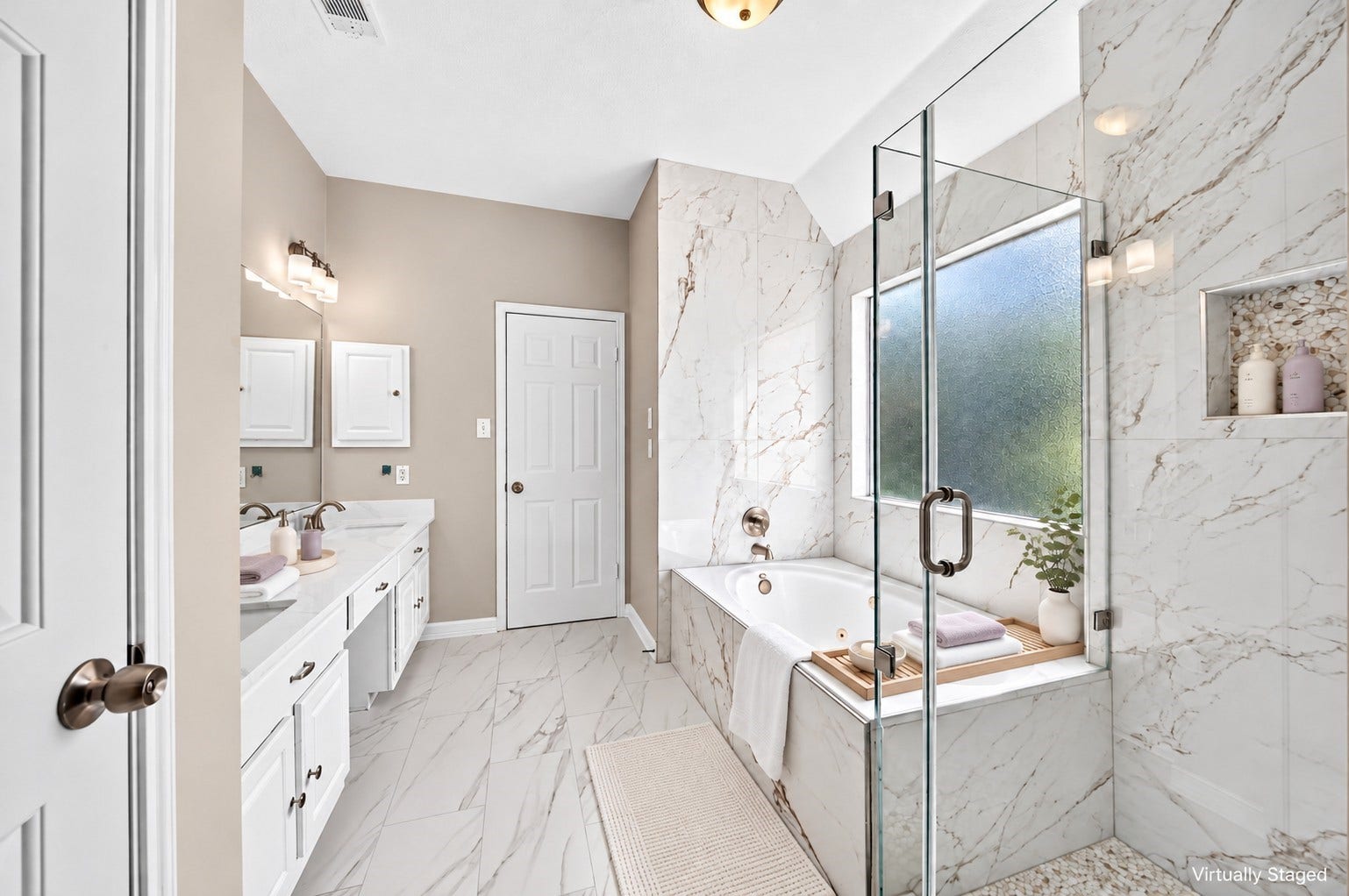 2130 Autumn Fern Drive, Katy, TX 77450 Primary Bathroom: Experience spa-inspired comfort with beautiful marble-look finishes, an enclosed glass shower, jetted soaking tub and spacious vanity area.