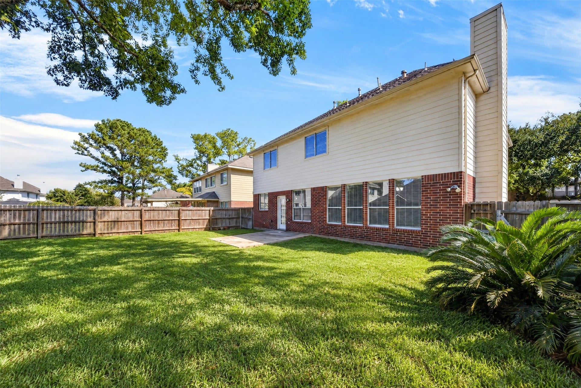 2130 Autumn Fern Drive, Katy, TX 77450 Backyard Alternate View
Spacious, fully fenced backyard features a lush green lawn, mature shade trees and an open patio area, offering an inviting setting for outdoor relaxation and entertaining.