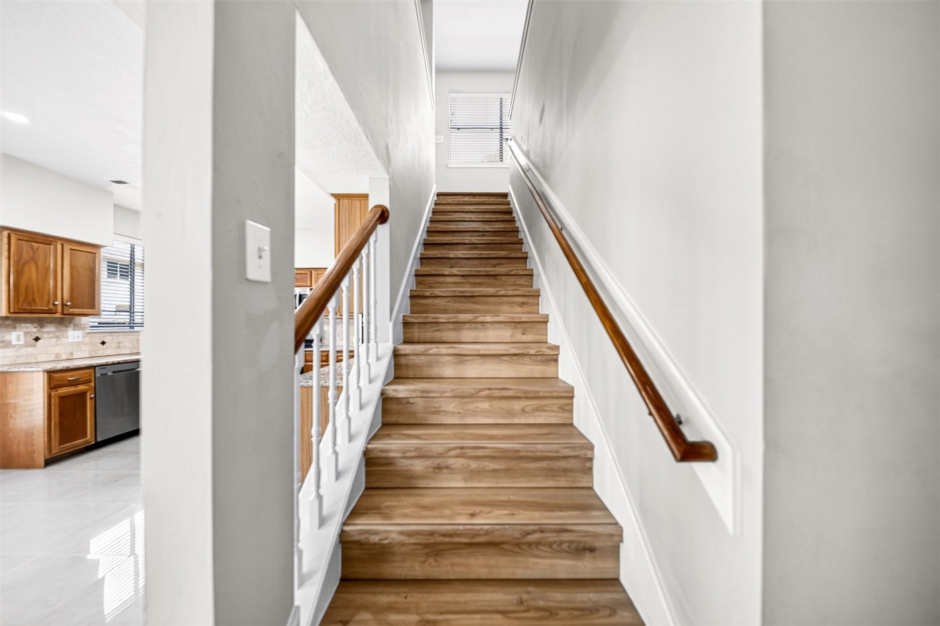 2130 Autumn Fern Drive, Katy, TX 77450 Staircase Updated Flooring
Beautiful staircase featuring wood-look flooring, crisp white balusters and warm wood handrails, creating an inviting transition to the home's spacious second level.