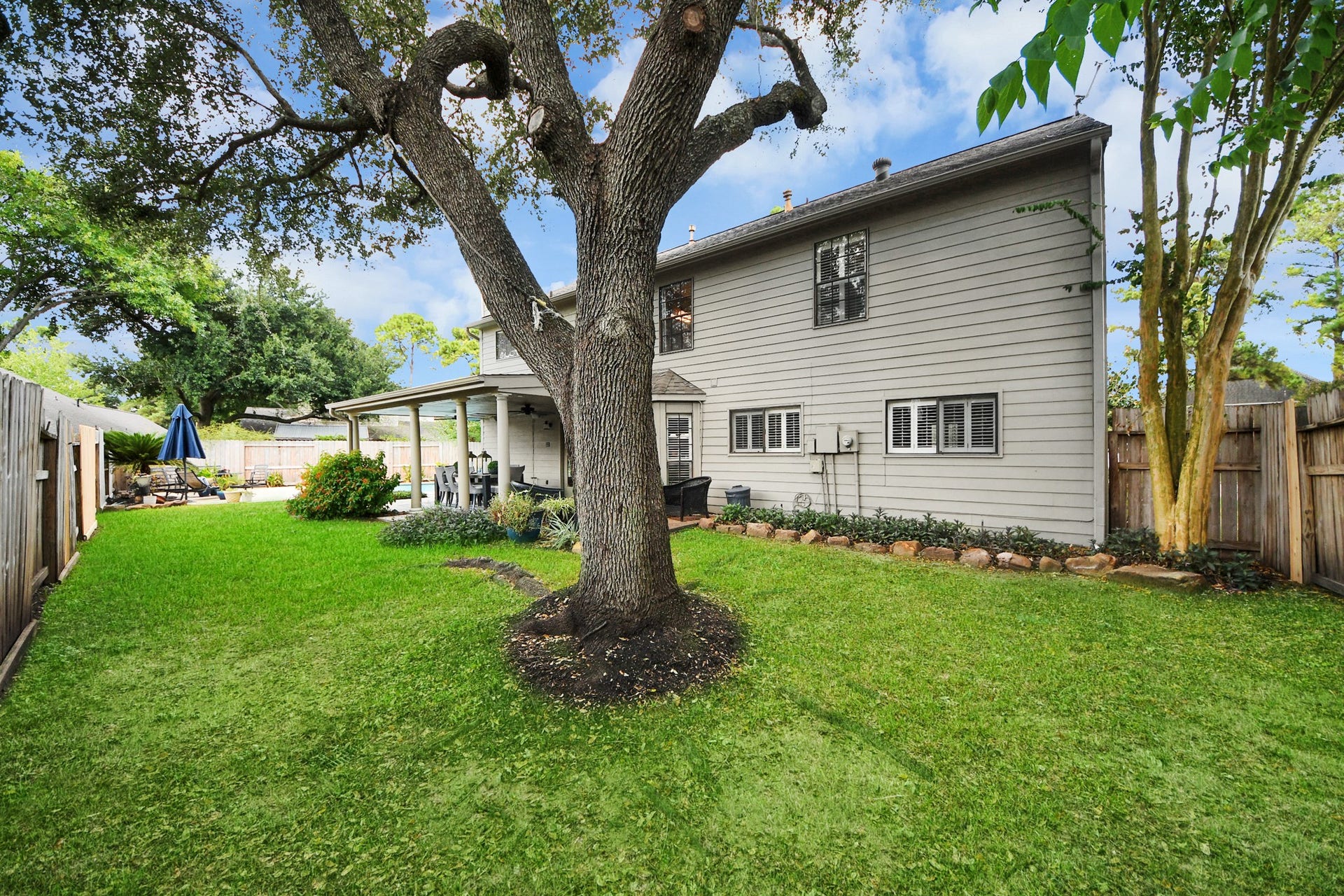 7615 Park Falls Drive, Houston, TX 77095 Exterior view of the rear of the home, showcasing the backyard and outdoor living spaces