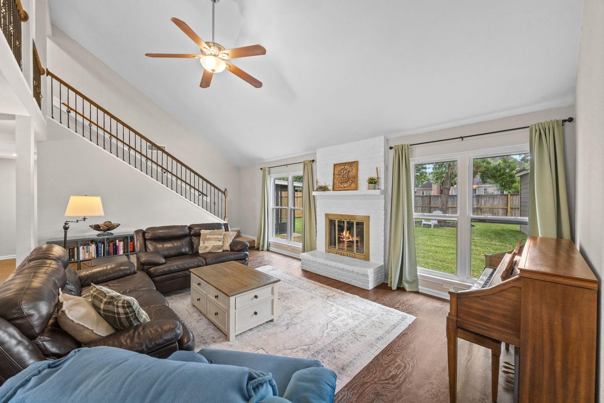 13823 Ivymount Drive, Sugar Land, TX 77498 Spacious but cozy living room with big windows, high ceilings, fireplace.