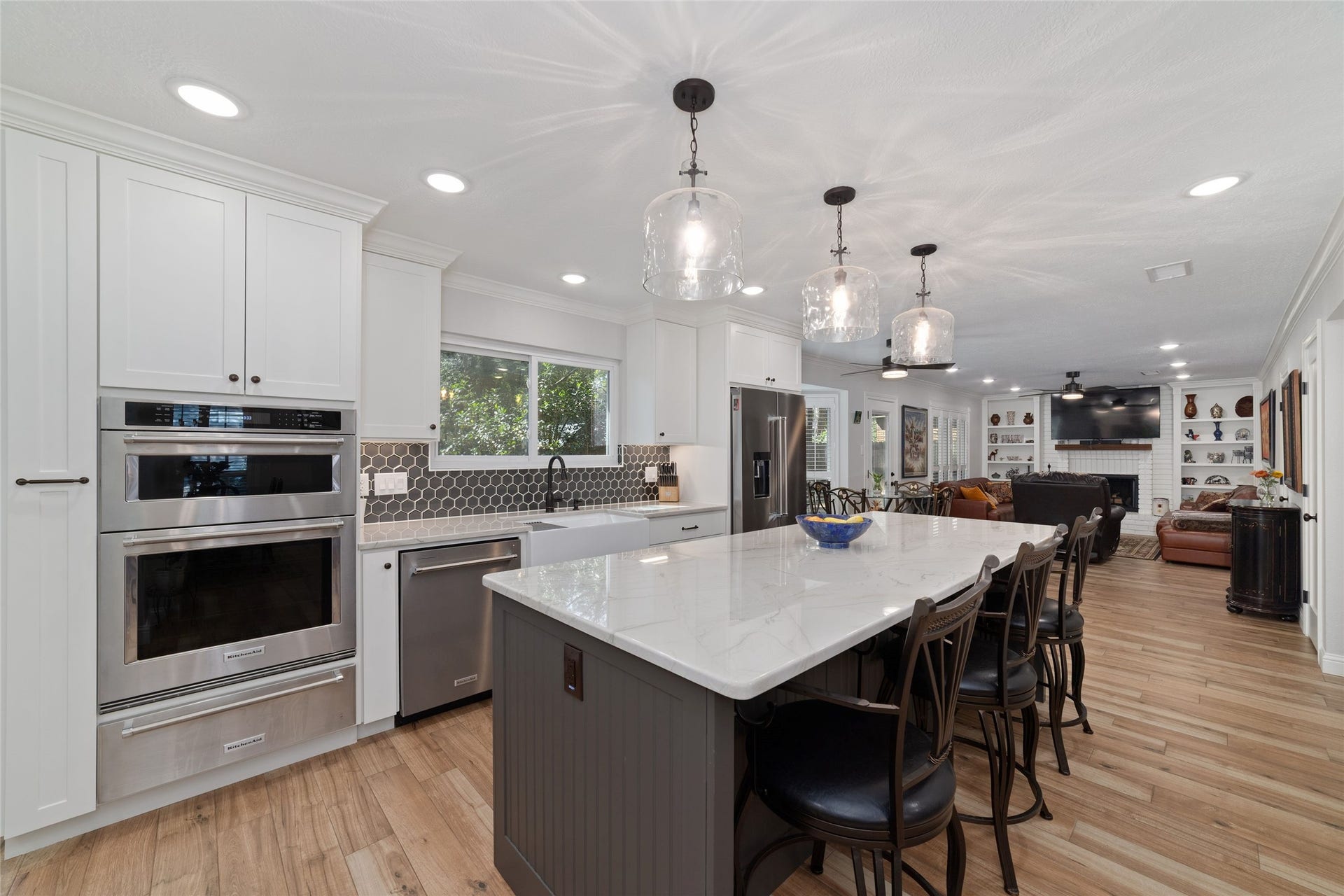 218 E Rainbow Ridge Circle, The Woodlands, TX 77381 Spacious and bright kitchen featuring a large island, modern stainless steel appliances, and stylish lighting, perfect for entertaining and culinary creativity.