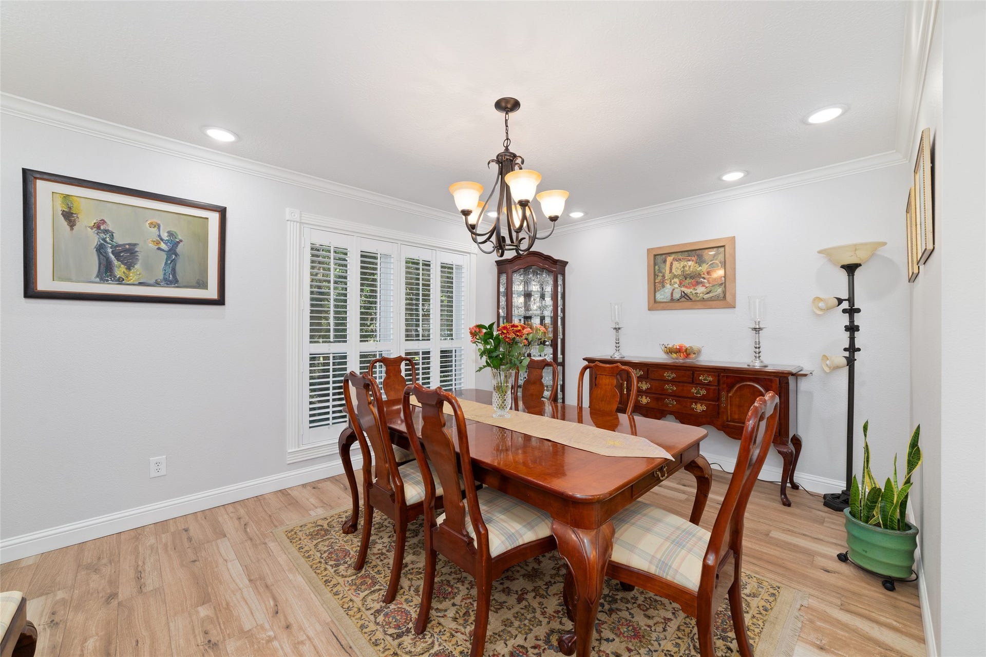 218 E Rainbow Ridge Circle, The Woodlands, TX 77381 Dining room features a new chandelier and abundant natural light from large windows.