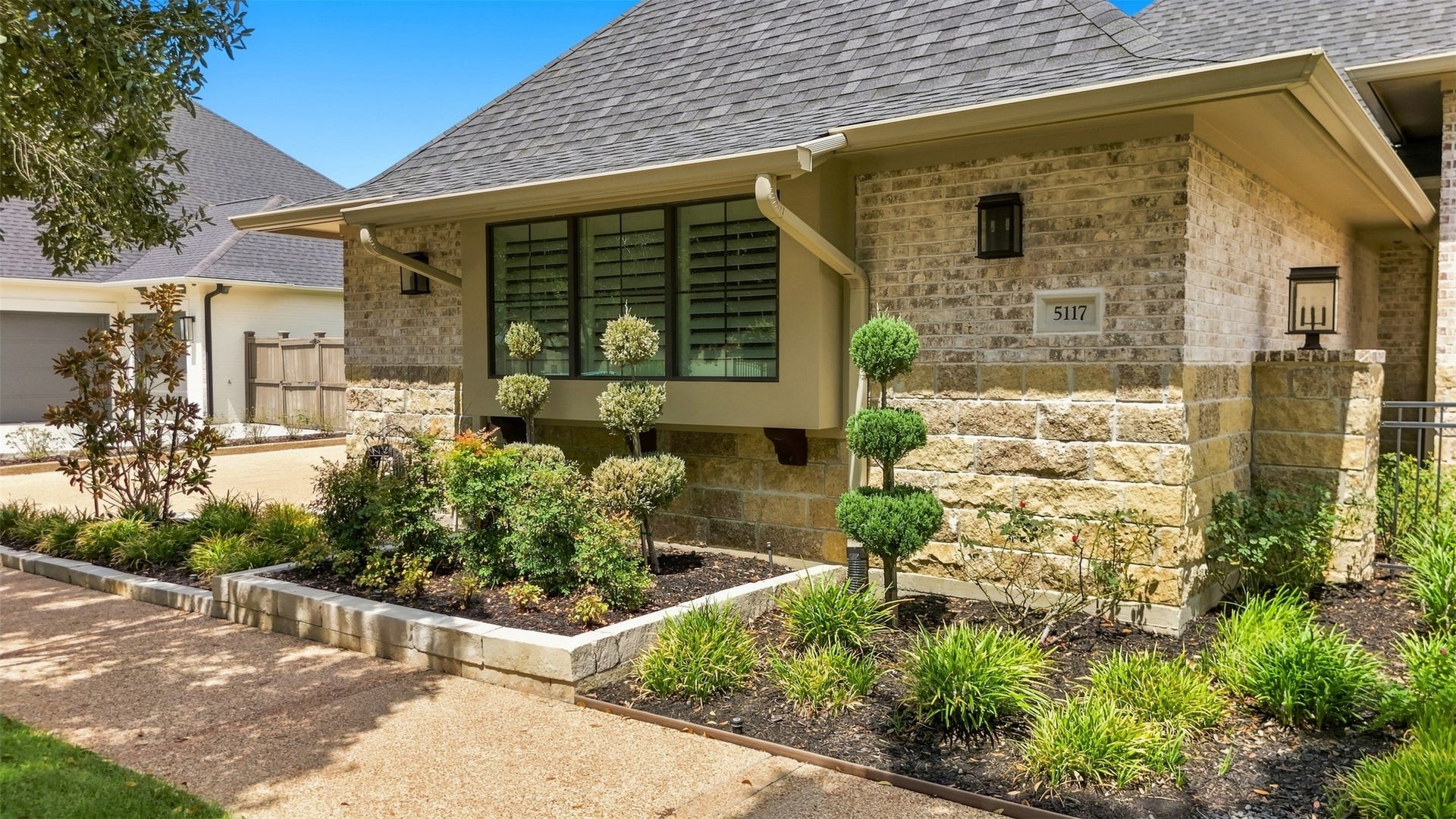 5117 Inverness Drive, Bryan, TX 77802 Another view of the beautifully landscaped front exterior and distinctive stone-and-brick architecture.