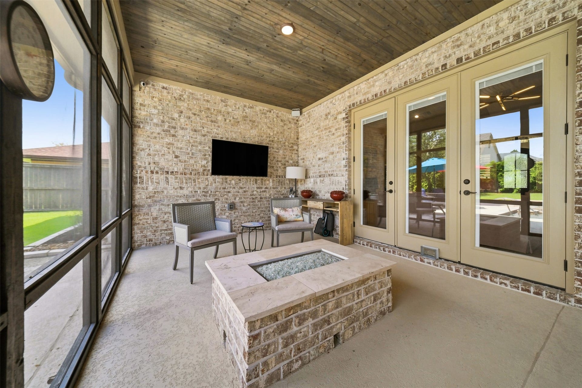 5117 Inverness Drive, Bryan, TX 77802 Inviting screened-in porch with a built-in fire pitperfect for year-round outdoor living and entertaining.