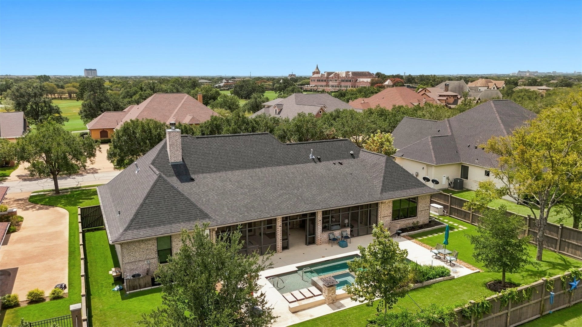 5117 Inverness Drive, Bryan, TX 77802 Aerial view of the home showcasing the private backyard, pool, screened porch, and beautifully maintained grounds.