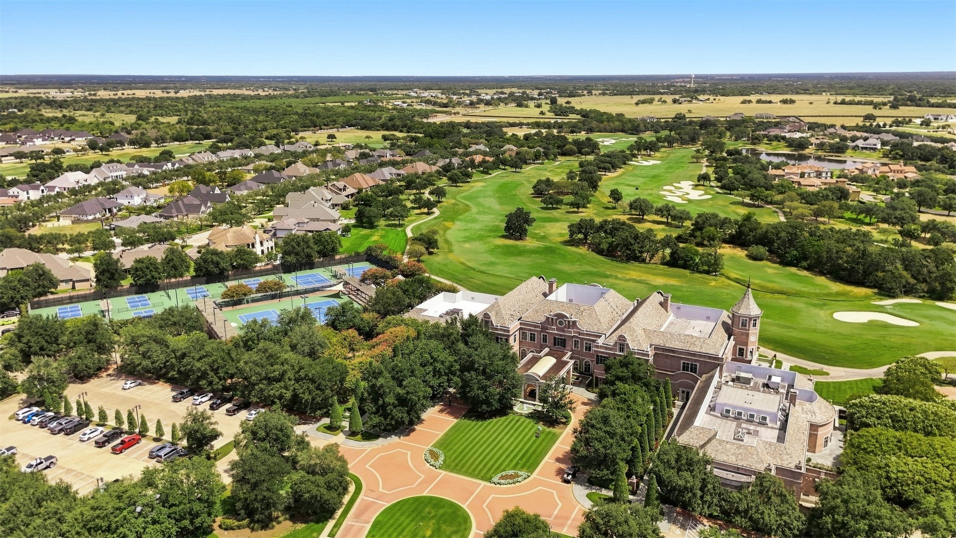 5117 Inverness Drive, Bryan, TX 77802 Aerial view of Miramont Country Club showcasing the clubhouse, golf course, tennis courts, and pickleball courts.