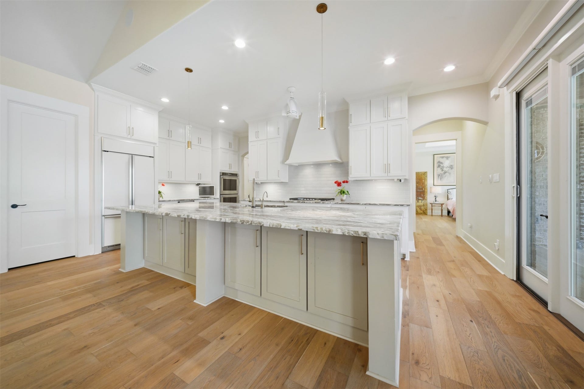 5117 Inverness Drive, Bryan, TX 77802 Spacious kitchen with built-in refrigerator, oversized island with seating and an open view from the great room.