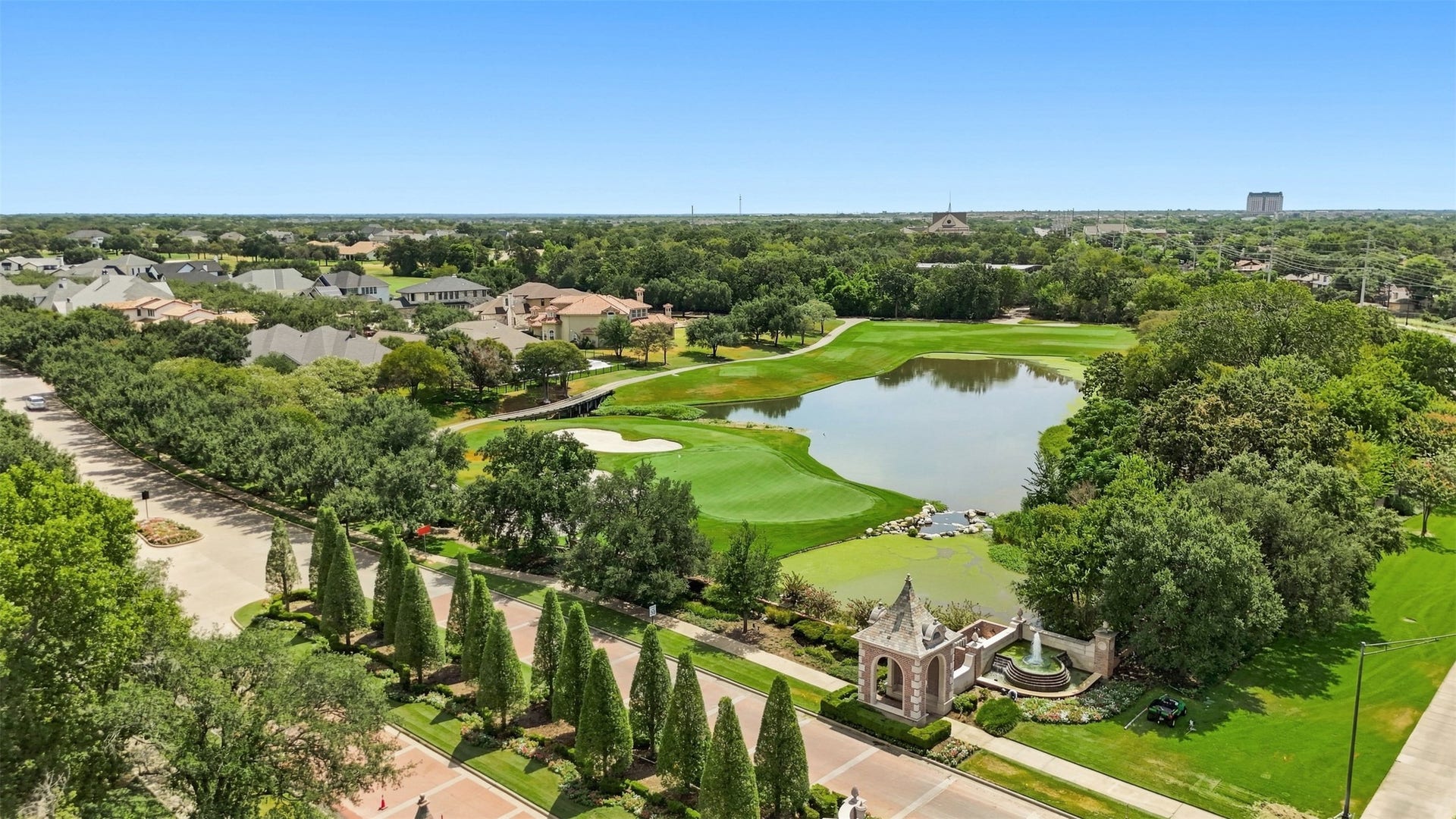 5117 Inverness Drive, Bryan, TX 77802 Aerial view showcasing the beautifully maintained Miramont community, picturesque golf course, and water features.