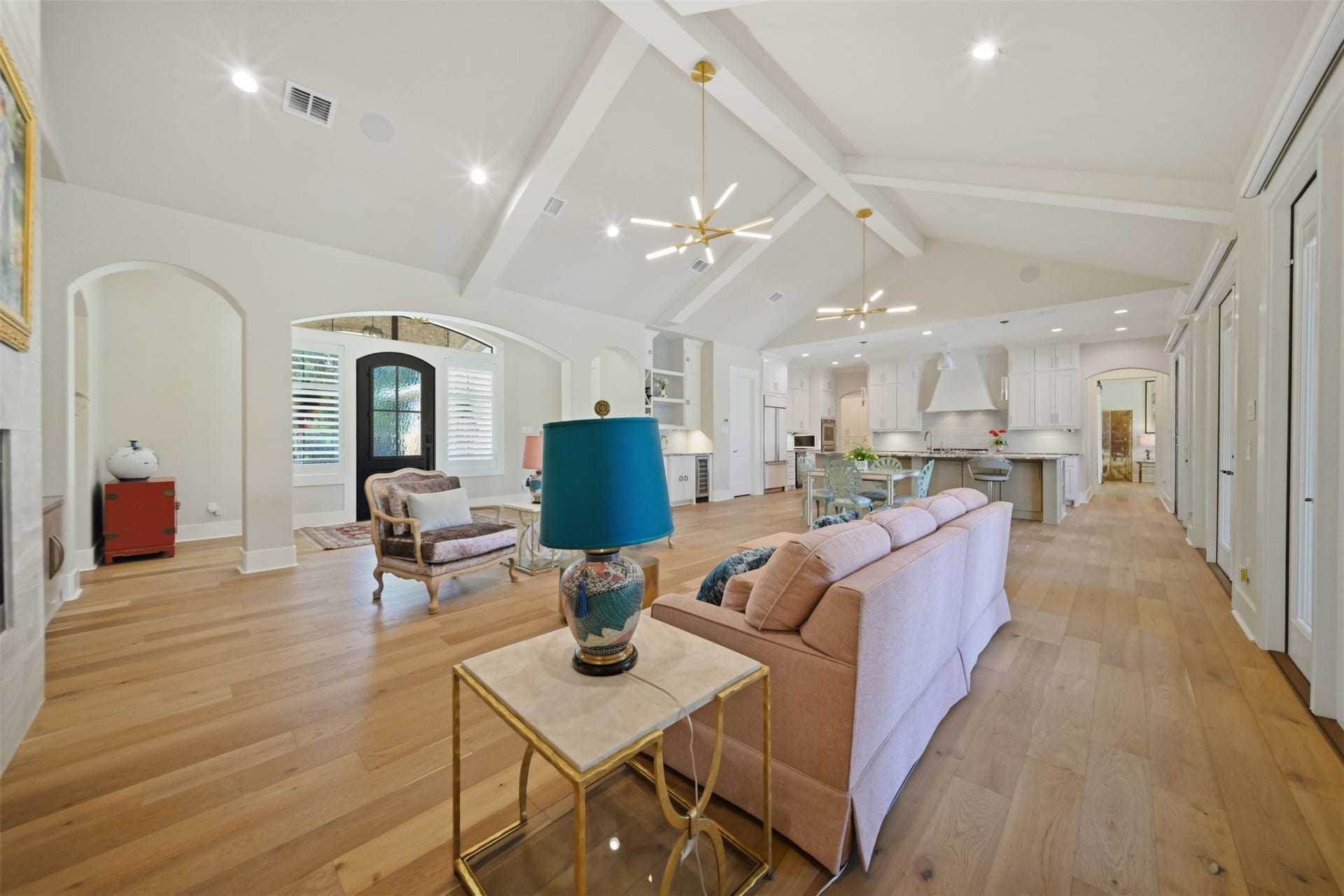 5117 Inverness Drive, Bryan, TX 77802 Open-concept great room with soaring cathedral ceiling and hardwood floors, flowing into the dining space and kitchen.