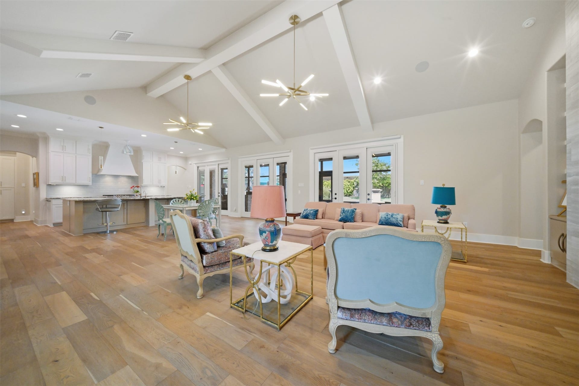 5117 Inverness Drive, Bryan, TX 77802 Expansive open-concept living, dining, and kitchen areas with soaring ceilings and seamless access to the screened porch and pool beyond.