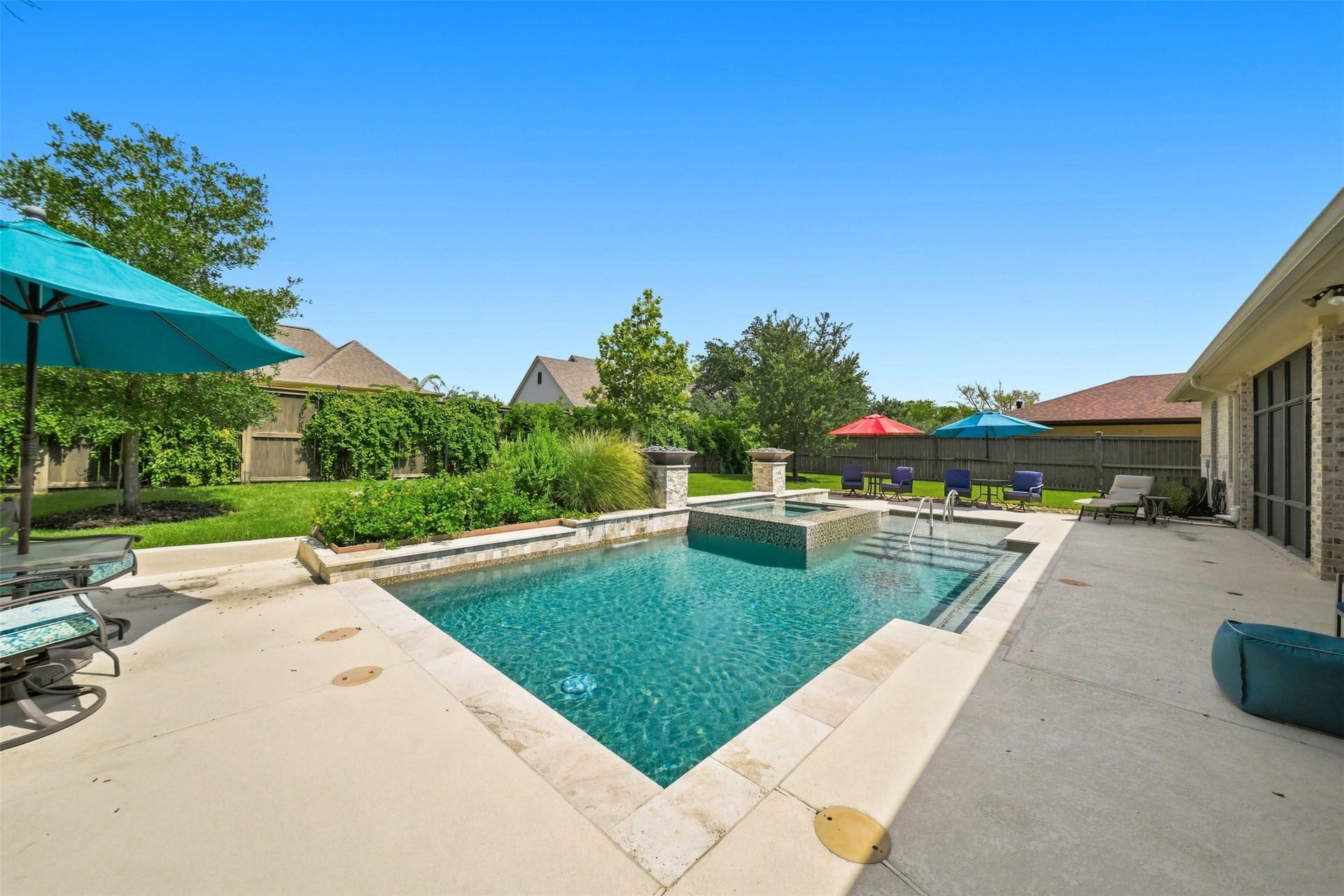 5117 Inverness Drive, Bryan, TX 77802 Resort-style heated pool and spa create a private backyard retreat.