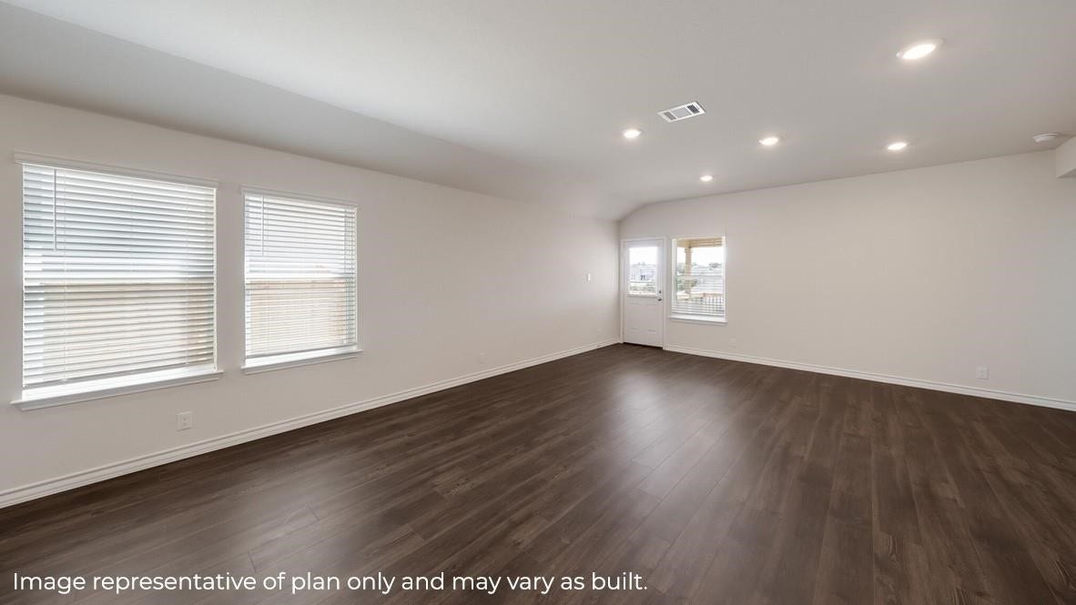 3831 Turnpike Drive, Fulshear, TX 77441 Spacious and bright living area featuring sleek wood flooring, ample natural light from multiple windows, and recessed lighting for a modern touch.