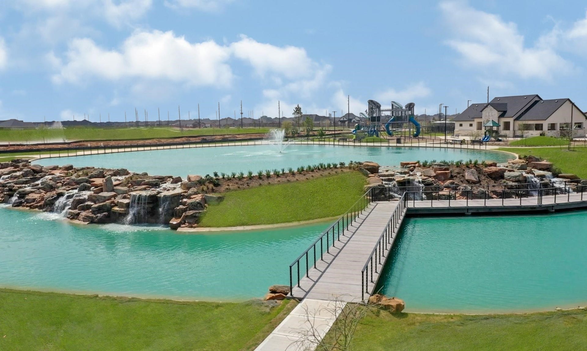 3831 Turnpike Drive, Fulshear, TX 77441 Experience serene living with this stunning community featuring a picturesque lake, cascading waterfalls, and a scenic bridge leading to a modern playground and clubhouse.