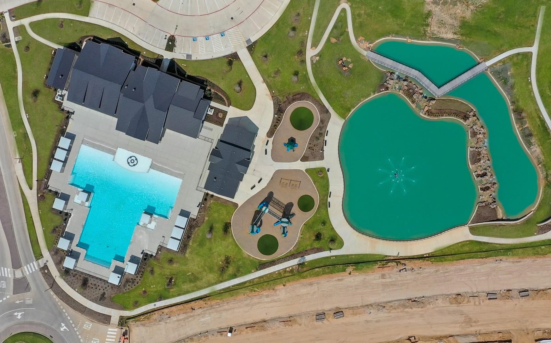 3831 Turnpike Drive, Fulshear, TX 77441 Luxurious community amenities include a large, resort-style pool, a tranquil pond with a fountain, and beautifully landscaped walking paths, providing a perfect blend of relaxation and recreation.