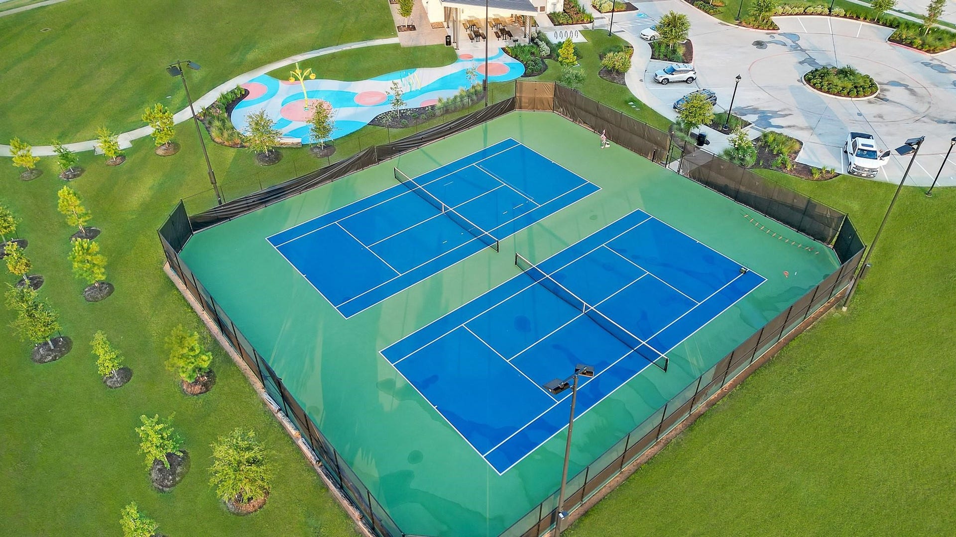 3831 Turnpike Drive, Fulshear, TX 77441 Enjoy active living with access to two pristine tennis courts, surrounded by lush greenery and a vibrant community space.