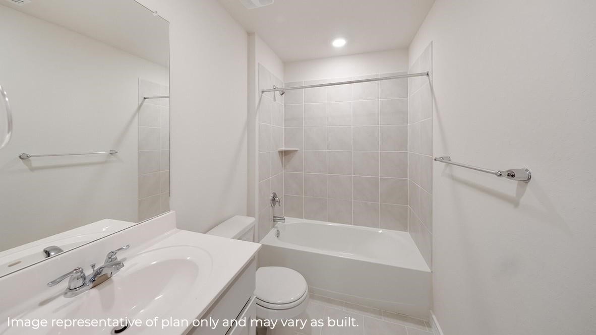 3831 Turnpike Drive, Fulshear, TX 77441 Bright and modern bathroom featuring a sleek vanity, tiled bathtub, and clean white finishes.