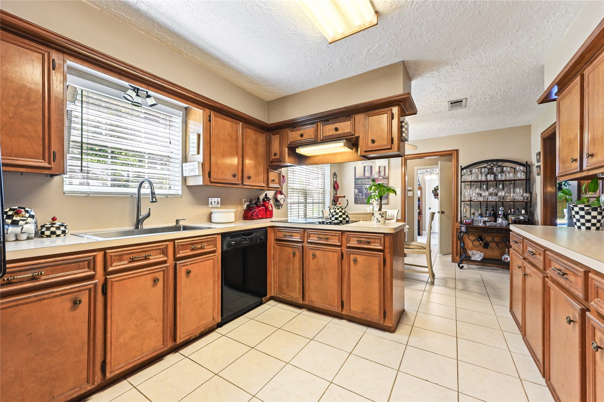 25803 Maplewood Drive, Spring, TX 77386 Spacious kitchen with warm wood cabinetry, ample counter space, and a cozy breakfast nook, perfect for family gatherings.