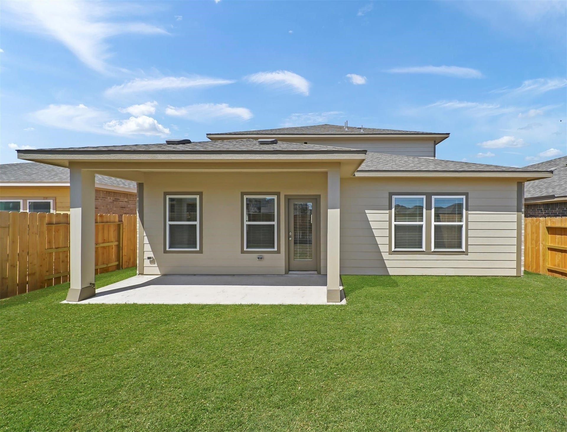 Spacious covered patio offers the perfect space for outdoor dining or relaxing, with a fully fenced backyard for privacy.