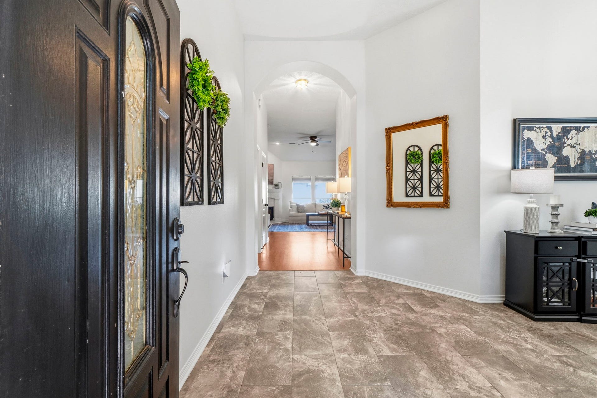 34019 Conroe Huffsmith Road, Magnolia, TX 77354 Inviting entryway with elegant tile flooring, high ceilings, and tasteful decor leading to an open, airy living space.