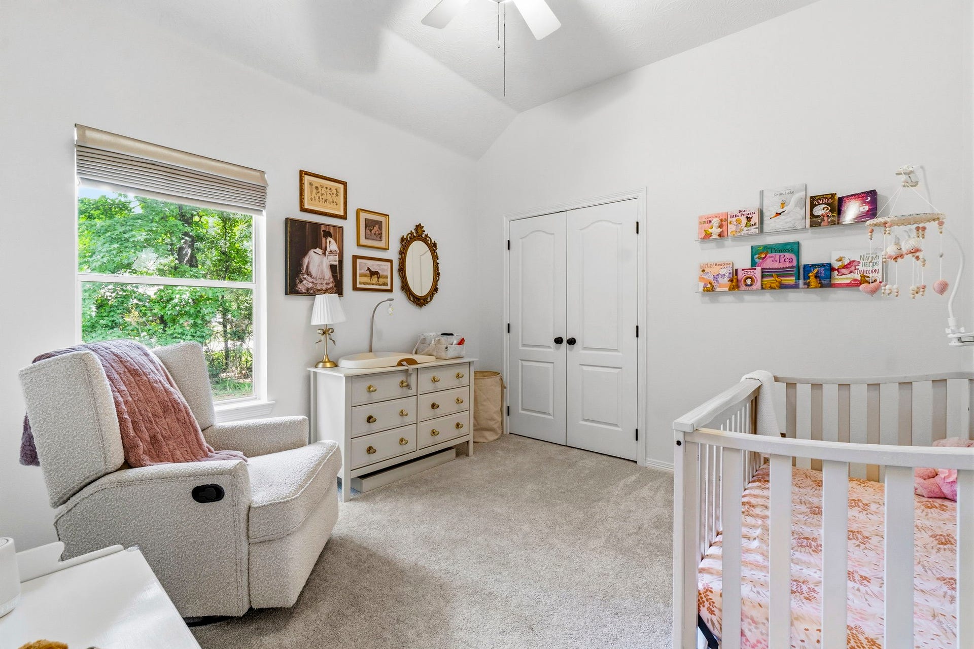 34019 Conroe Huffsmith Road, Magnolia, TX 77354 Charming nursery with soft carpeting, a cozy armchair, and a crib, enhanced by a large window bringing in natural light.
