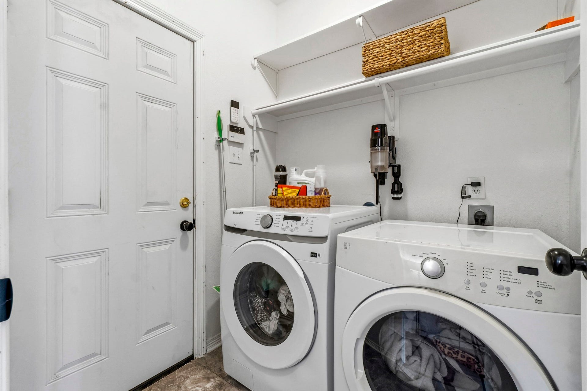 34019 Conroe Huffsmith Road, Magnolia, TX 77354 Convenient laundry room equipped with modern washer and dryer, ample shelving for storage, and easy access to the adjacent area.