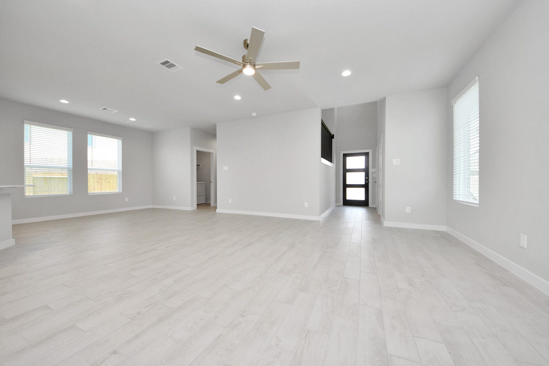 Gather the family and guests together in your lovely living room! Featuring soaring high ceilings, recessed lighting, ceiling fan, custom paint, gorgeous floors, and large windows that provide plenty of natural lighting throughout the day. Sample photo of completed home with similar floor plan. Actual colors and selections may vary.