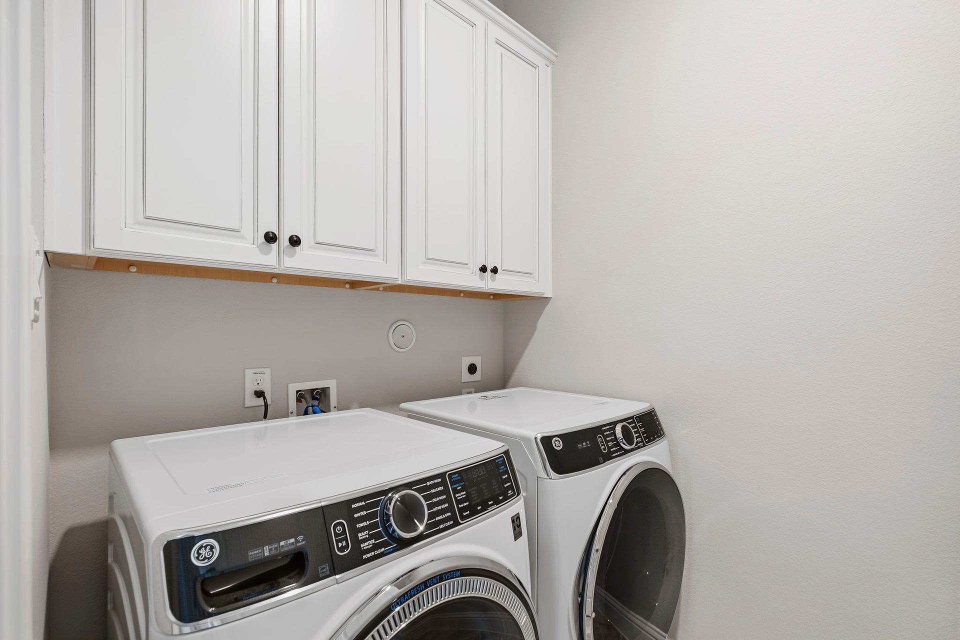 19314 Trotting Green Trail, Tomball, TX 77377 The laundry room complete with cabinets and an extra storage space that is hidden around the corner