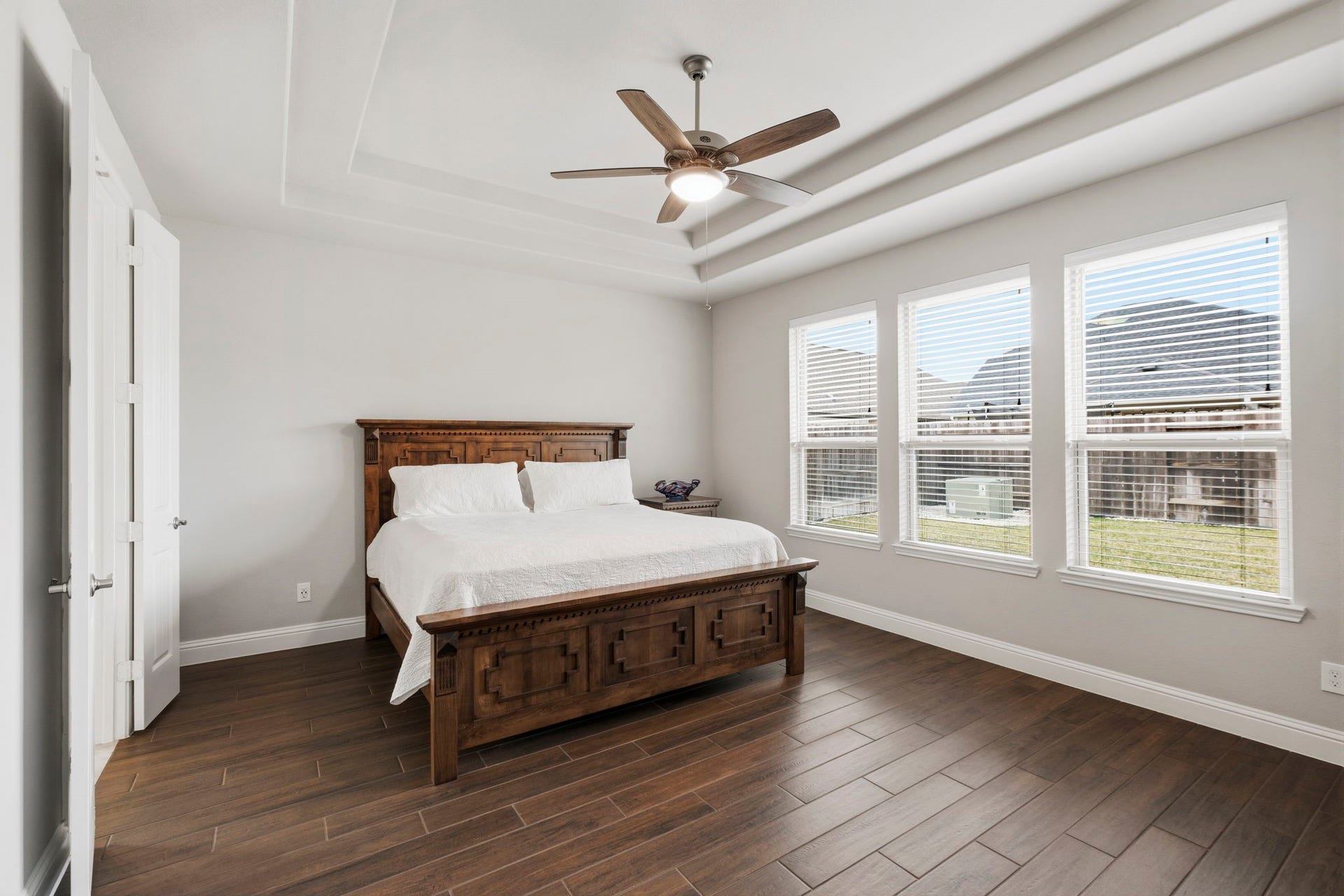 19314 Trotting Green Trail, Tomball, TX 77377 The primary bedroom with ceiling fan and natural light from the windows