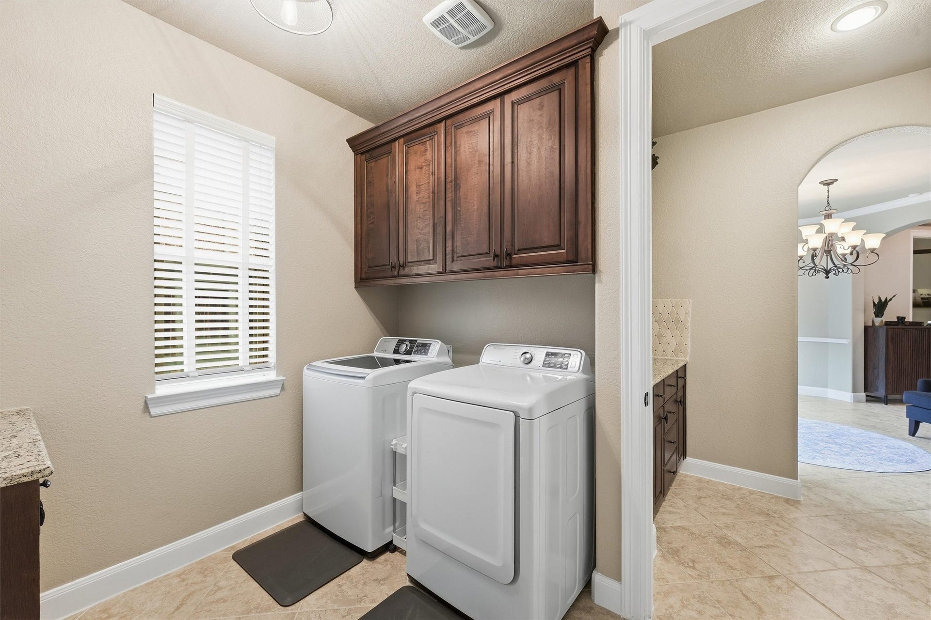 210 Fox Squirrel Court, Pinehurst, TX 77362 Convenient utility room with extra storage and access to the primary bathroom/closet