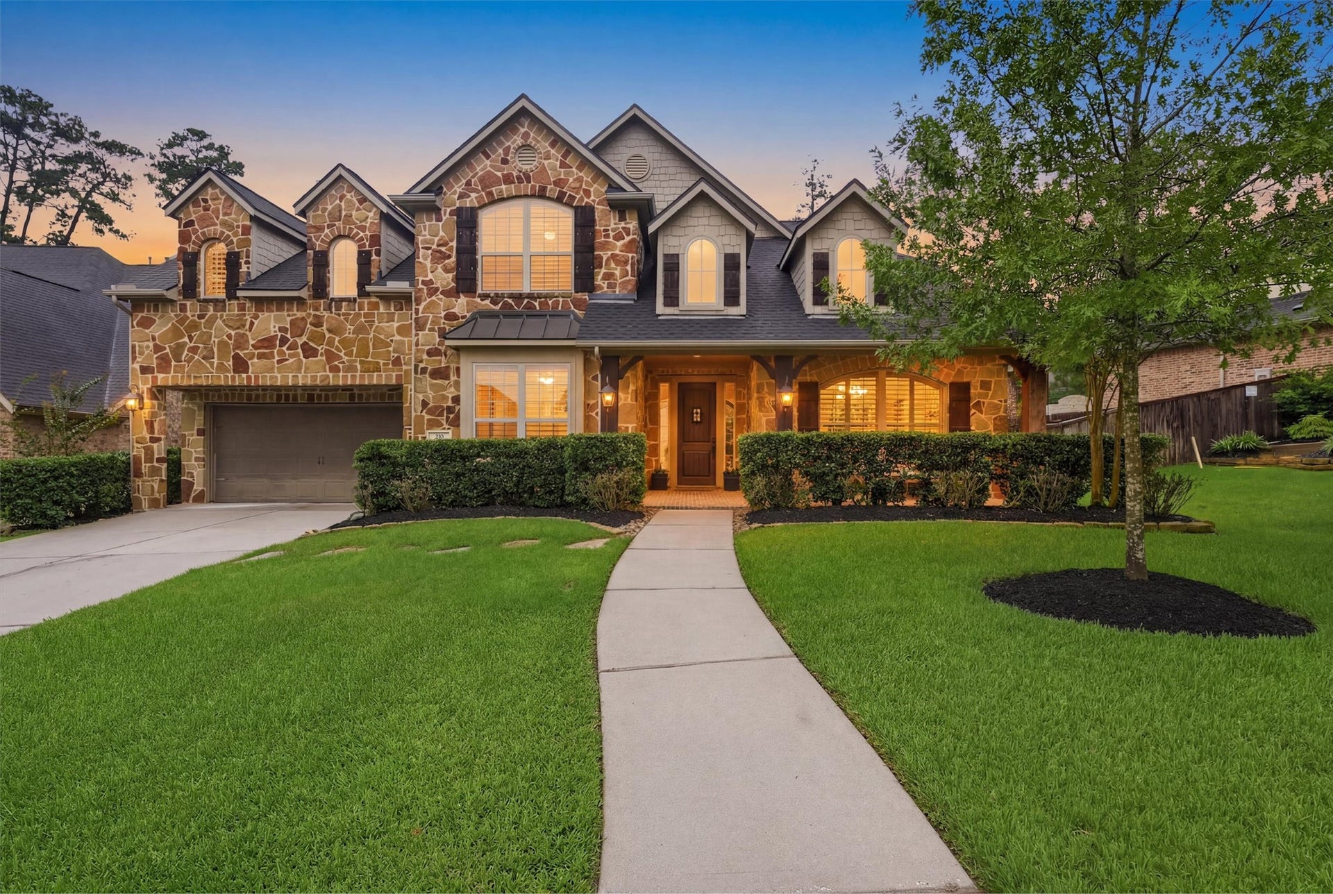 210 Fox Squirrel Court, Pinehurst, TX 77362 Timeless curb appeal with beautiful landscaping