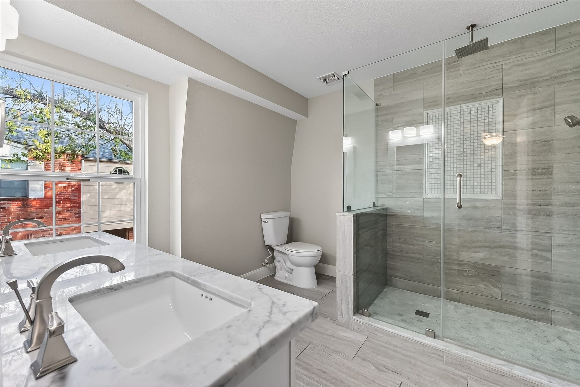 6351 Briar Rose Drive, #149, Houston, TX 77057 Spa-like primary bath featuring custom shower, upgraded fixtures, and elegant marble countertops.