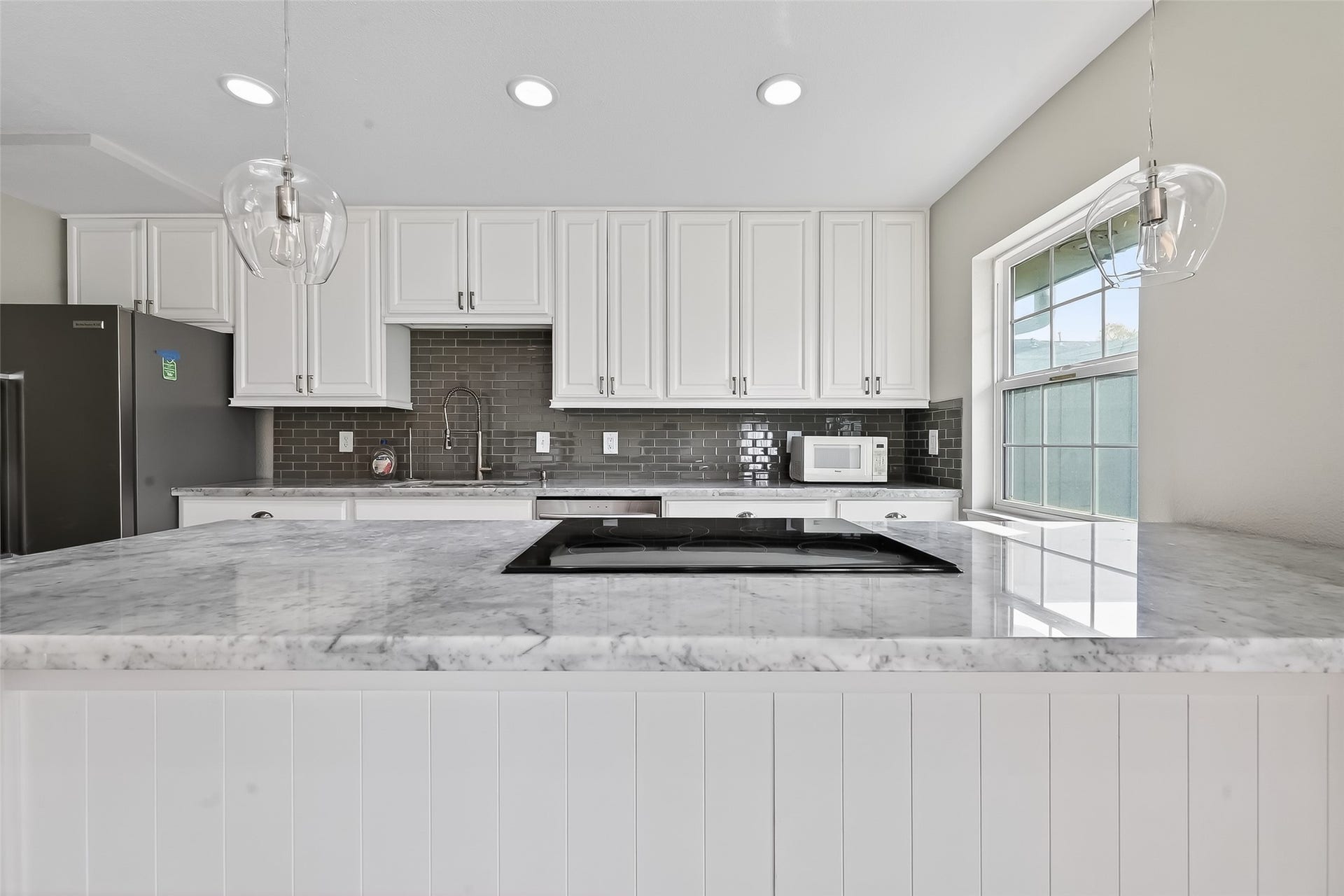 6351 Briar Rose Drive, #149, Houston, TX 77057 Modern Houston townhome kitchen with Carrera marble counters, designer finishes, and functional layout for everyday living.