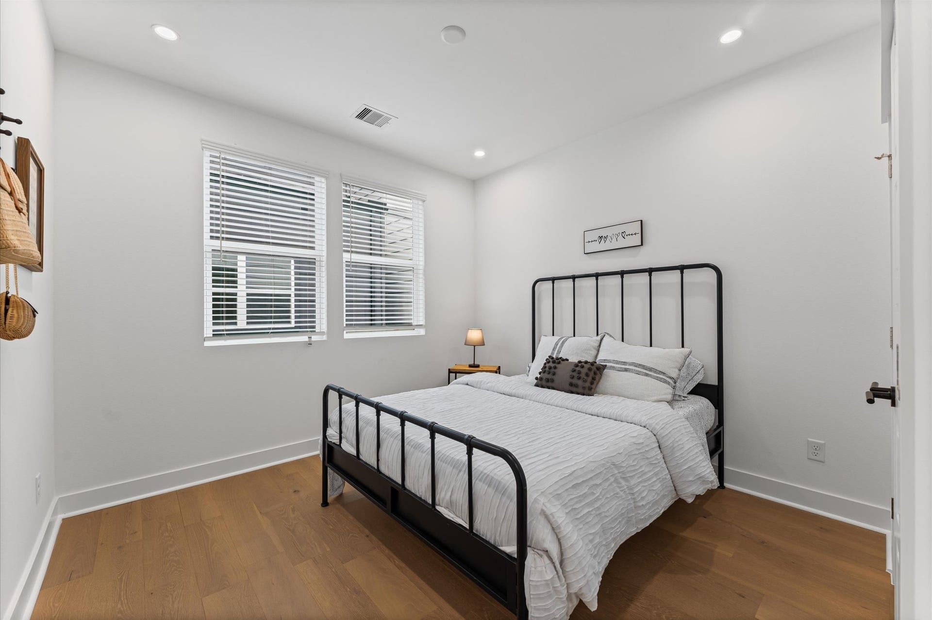 412 Neyland Street, #F, Houston, TX 77022 This secondary bedroom on the second floor exudes warmth and sophistication with its rich engineered hardwood flooring, adding a touch of elegance to the space. The smooth, durable surface enhances the rooms clean lines and complements a variety of dcor from cozy and traditional to sleek and modern. Natural light dances across the wood grain, creating a serene atmosphere ideal for rest, work, or creative pursuits.