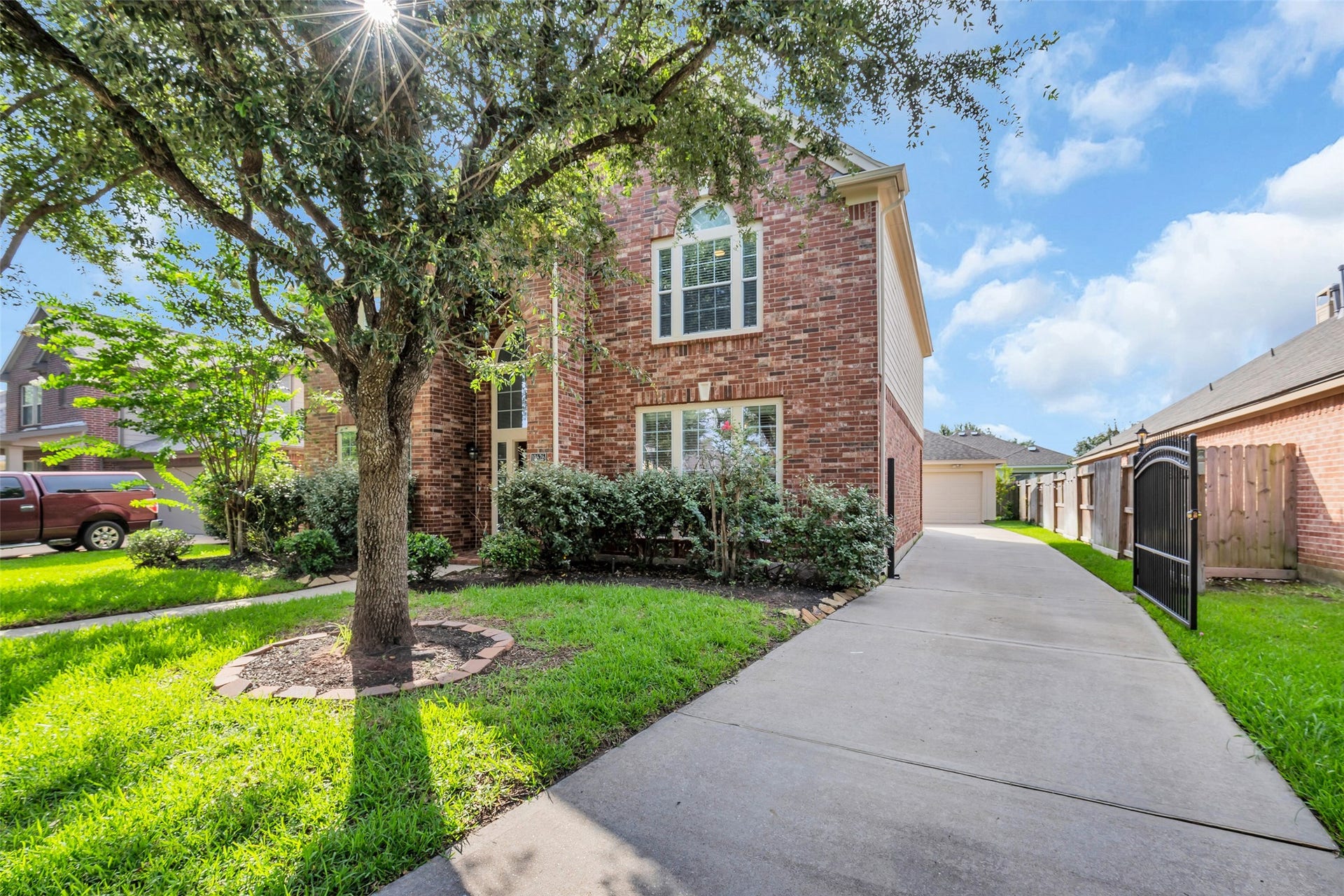 10626 Cortland Ridge Lane, Cypress, TX 77433 A long driveway for ample parking space! With an iron gate with remote controlled access